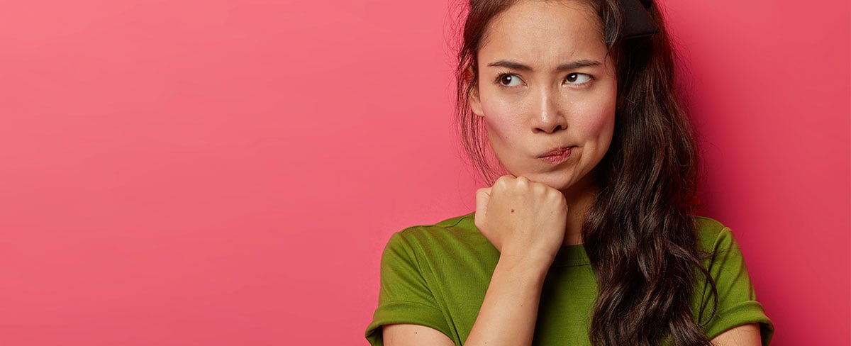 Woman with long dark hair in green shirt