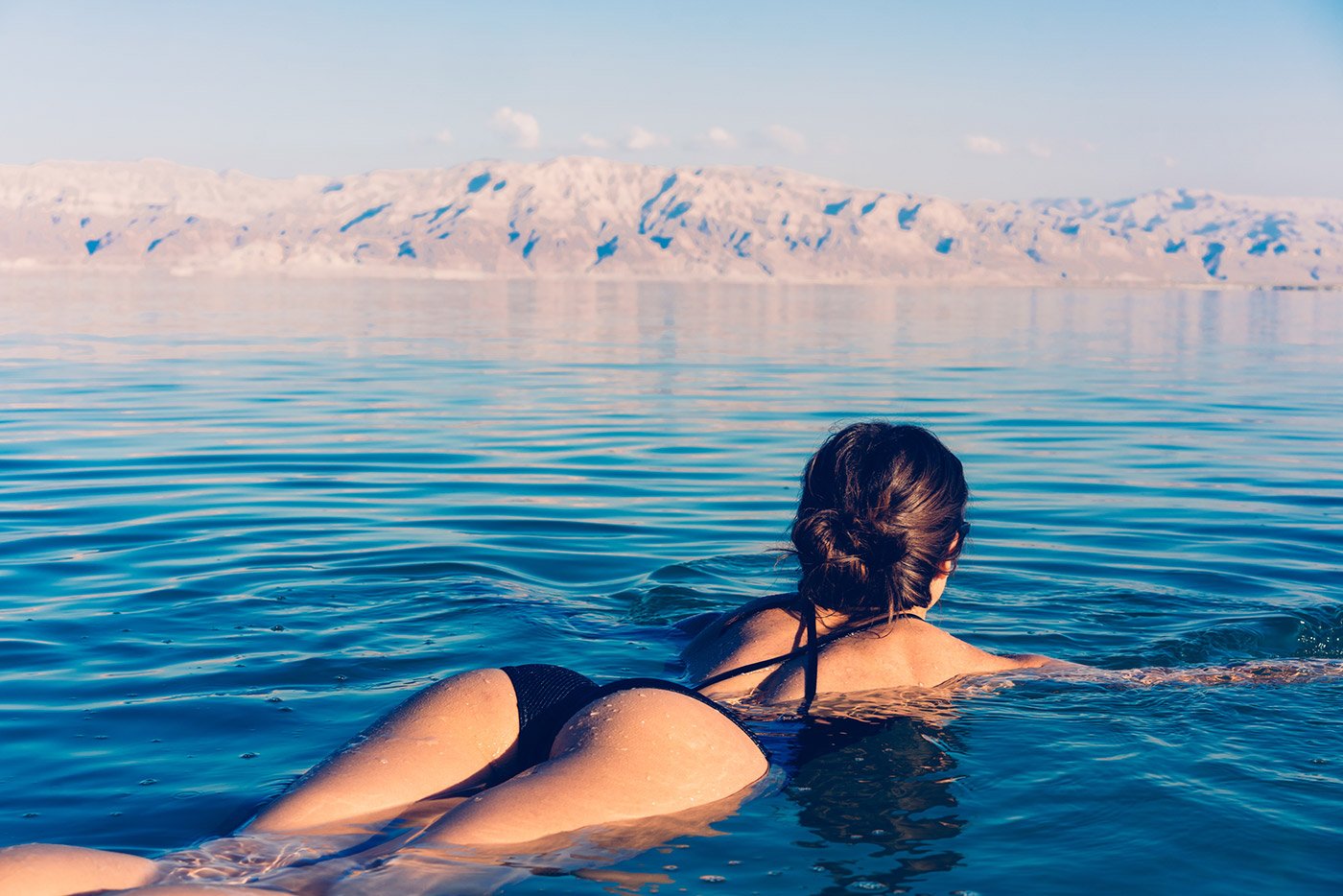 plastic-surgery-hawaii-hero-1 Person in black swimsuit floats on calm water