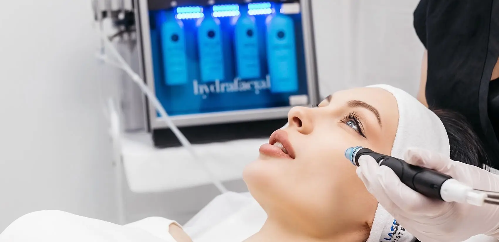 A person gets a HydraFacial with a device